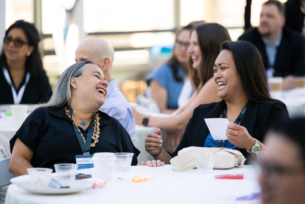 Women laughing at a table
